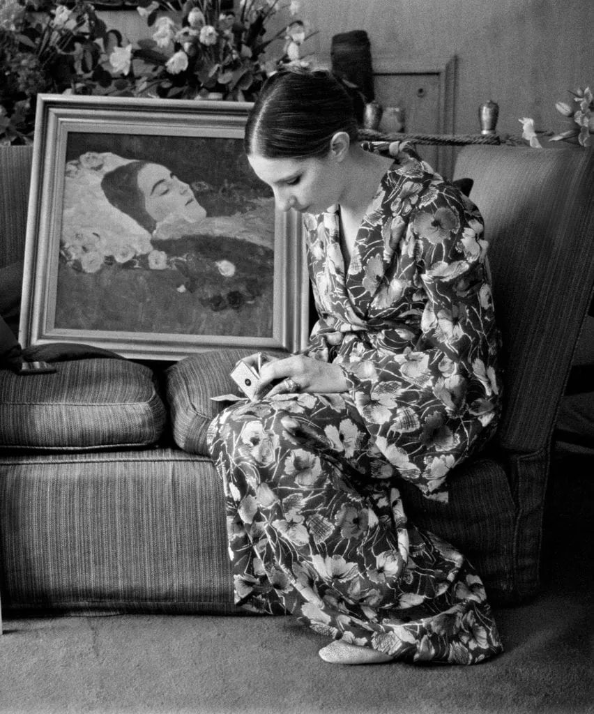 Barbra Streisand writing a check to purchase a Gustav Klimt painting at Claridge’s Hotel in London, photographed by Lawrence Schiller, 1969