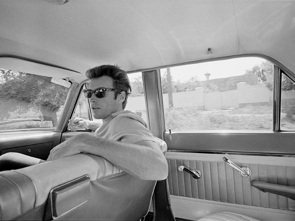 Clint Eastwood seated in the back of a car in Zagreb, Yugoslavia, photographed in 1969 by Lawrence Schiller