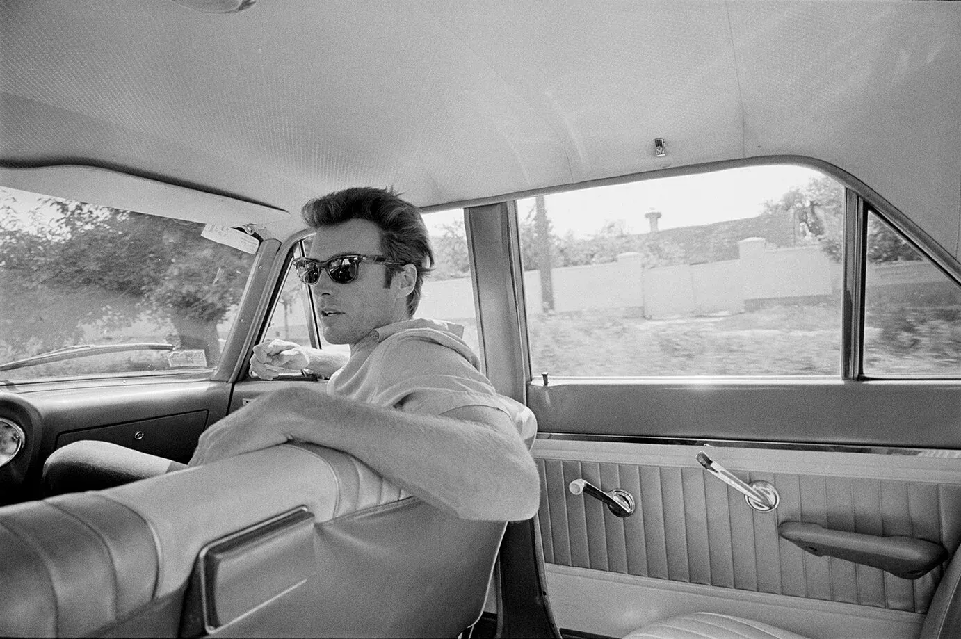 Clint Eastwood seated in the back of a car in Zagreb, Yugoslavia, photographed in 1969 by Lawrence Schiller