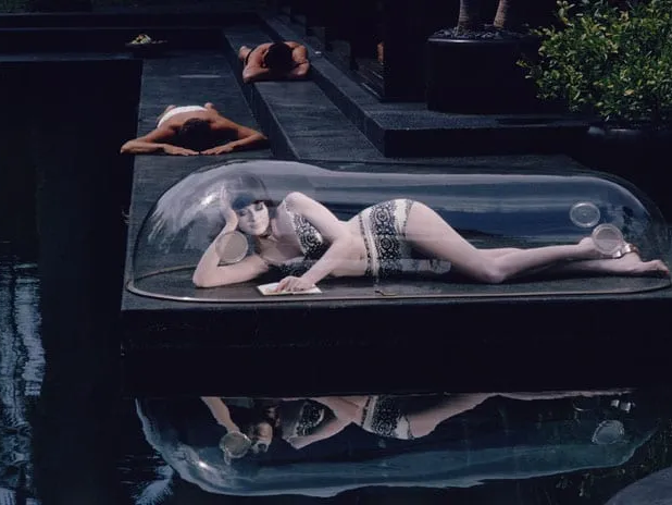 Girl in a Bubble photography showing a woman reclining inside a clear dome above water in Los Angeles, 1964