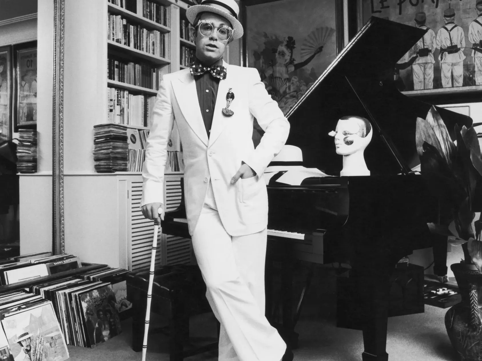 Elton John standing beside his piano at his home in Windsor during a 1974 album shoot