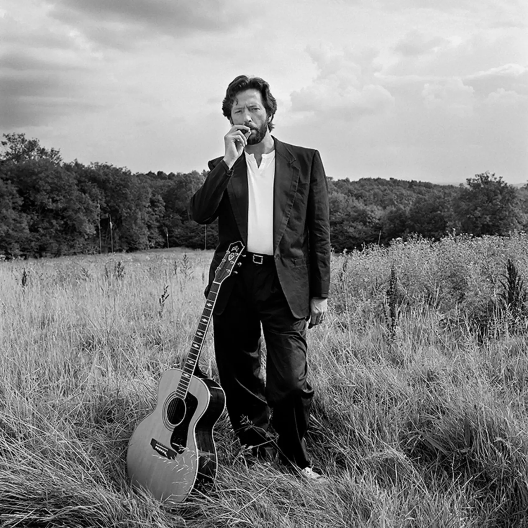 Eric Clapton posing with his guitar near his home in Surrey, photographed by Terry O’Neill in 1993