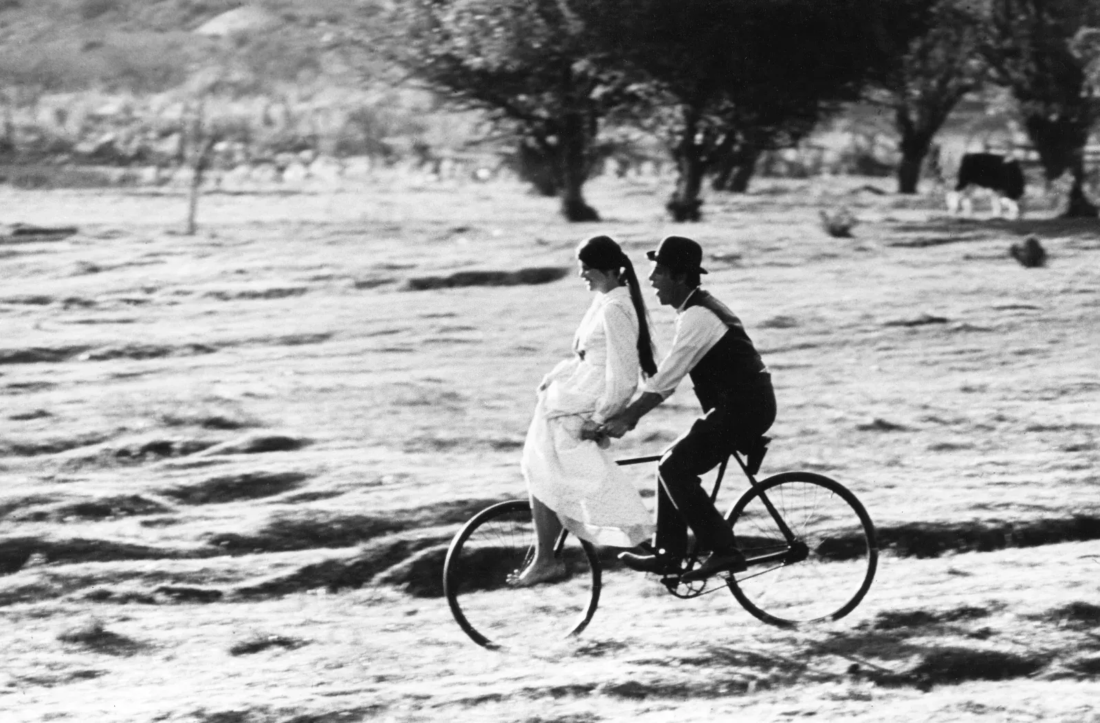 Paul Newman and Katharine Ross riding a bicycle during the filming of Butch Cassidy and the Sundance Kid, Mexico, 1968