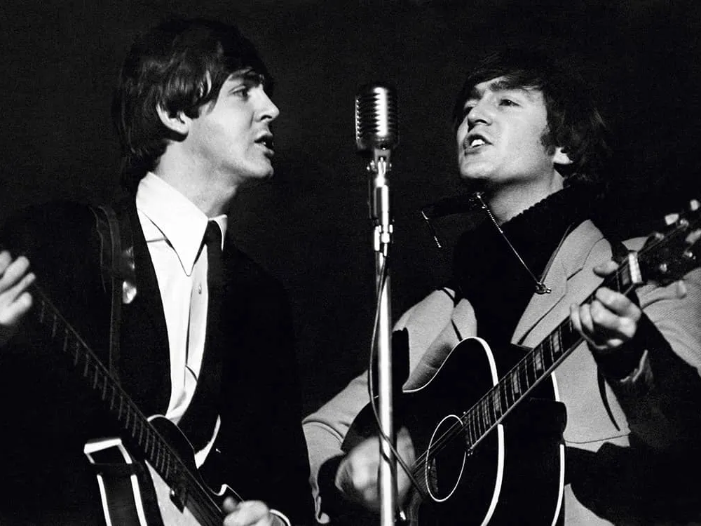 Paul McCartney and John Lennon rehearsing at Wembley Studios, photographed by Terry O’Neill, April 1964