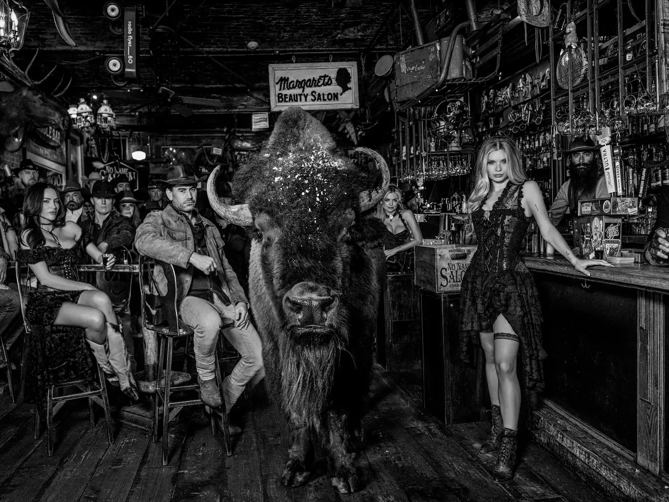 A photograph of a group of people in a bar by photographer David Yarrow.