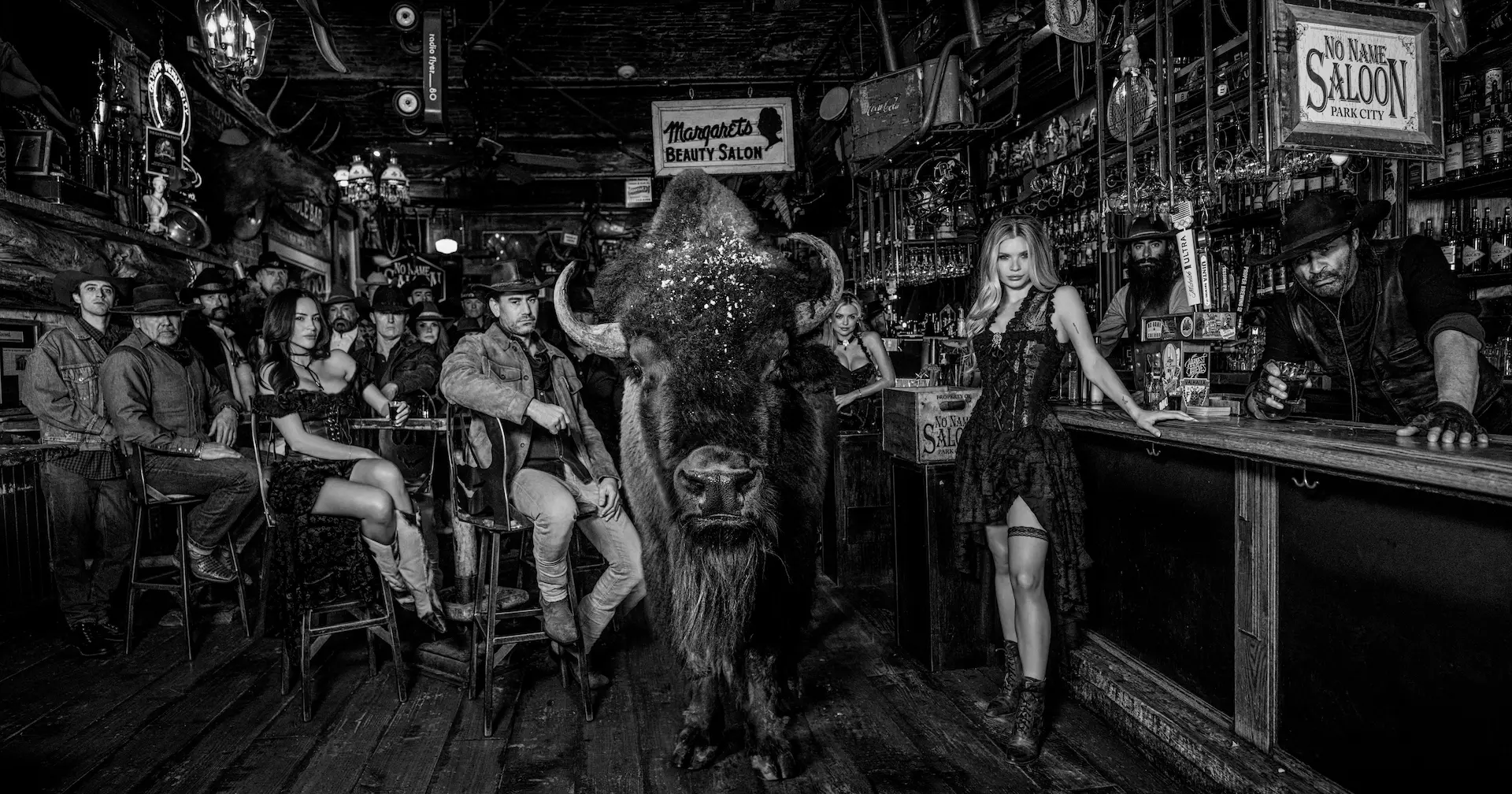 A photograph of a group of people in a bar by photographer David Yarrow.