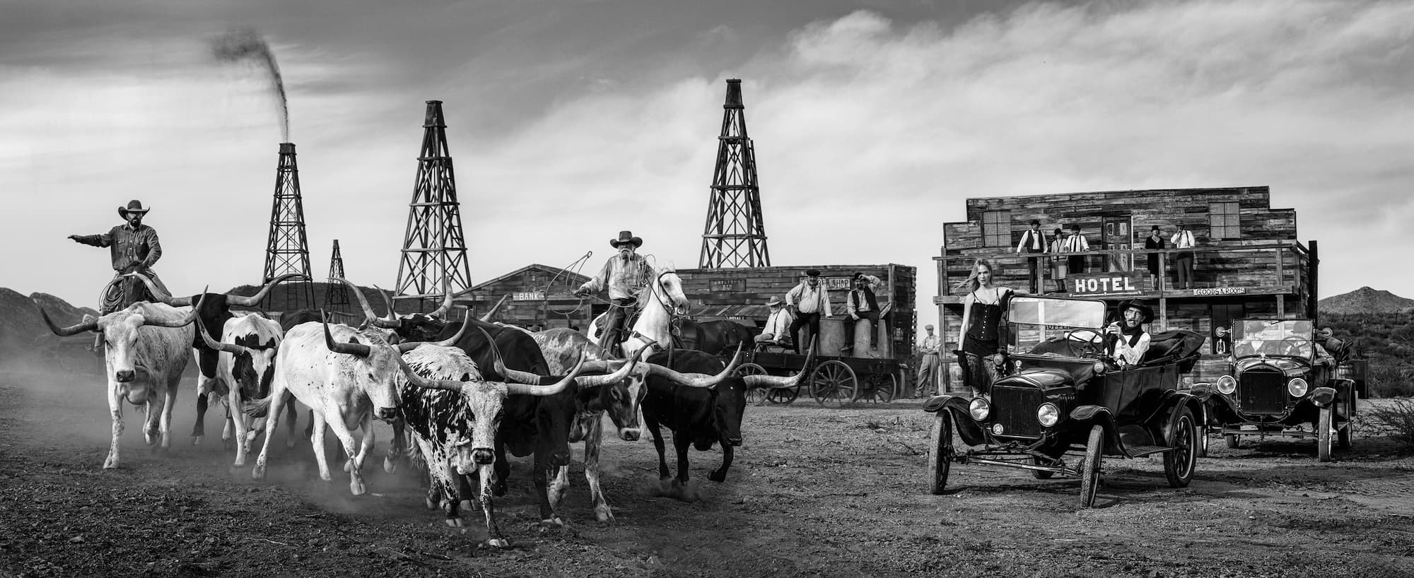 "Cattle and Oil" by David Yarrow, West Texas, Texas, 2025. Black and white photograph.