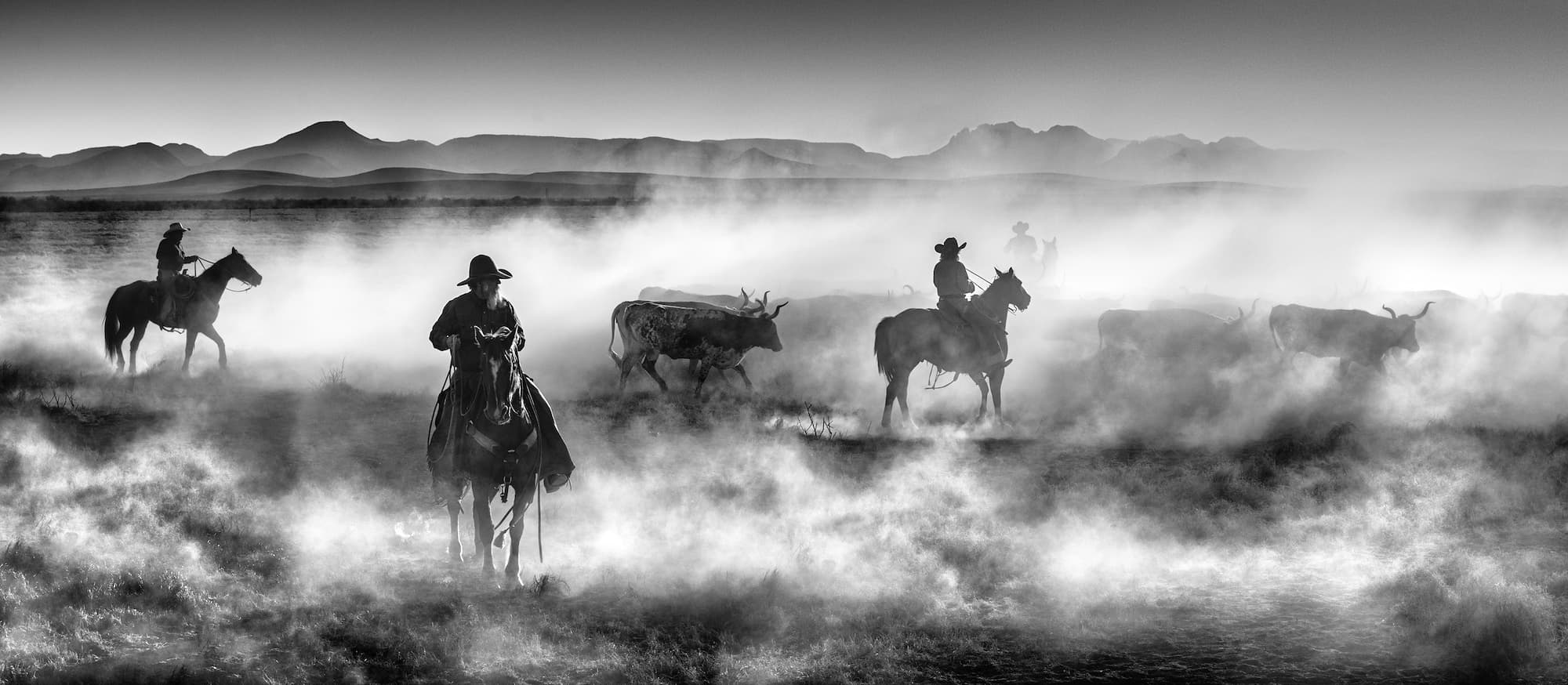 "Drovers" by David Yarrow, West Texas, Texas, 2021. Black and white photograph.