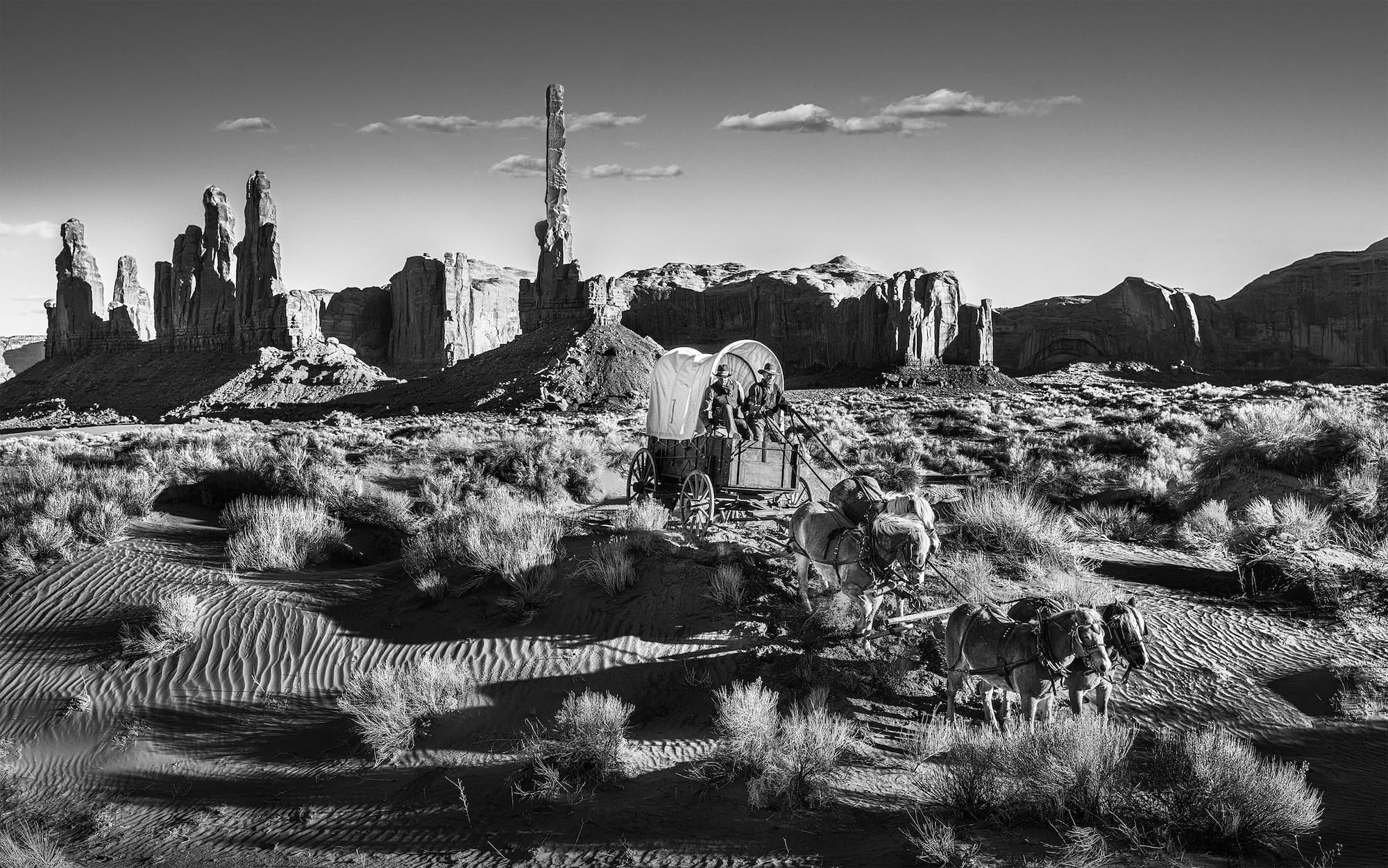 "Hostile Territory" by David Yarrow, Monument Valley, Utah, 2022. Black and white photograph.