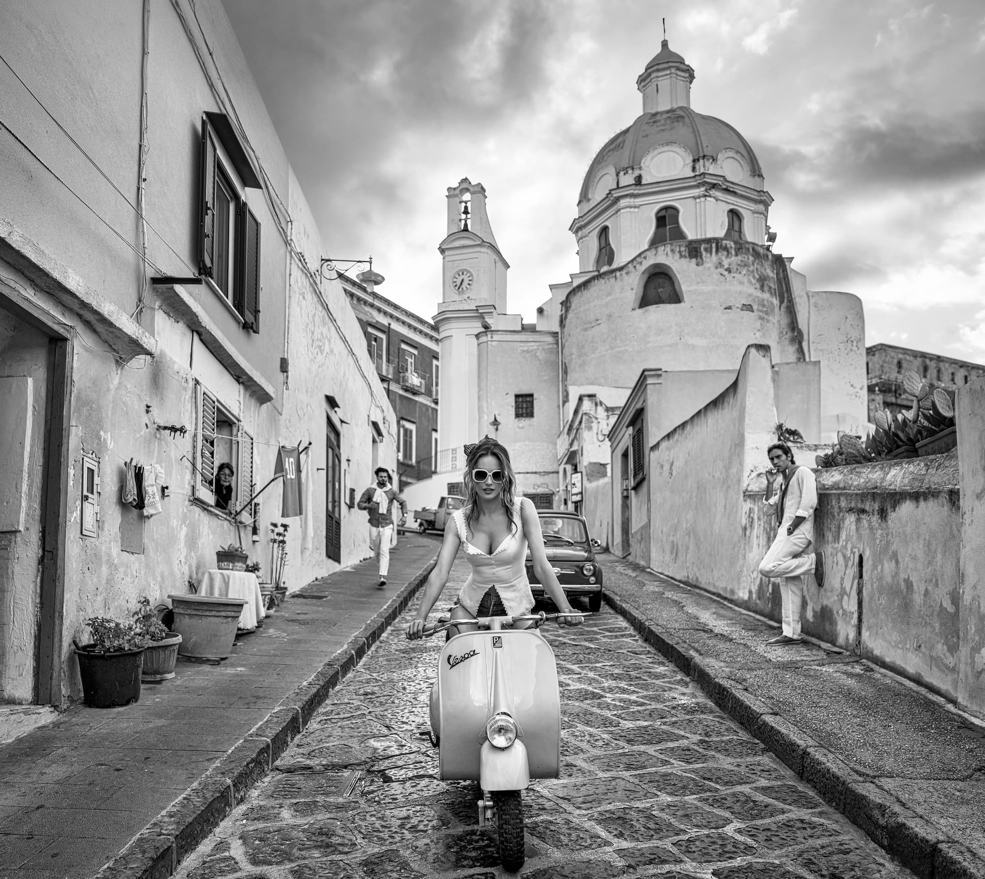 "The Girl on the Vespa" by David Yarrow, Procida, Italy, 2025. Black and white photograph.