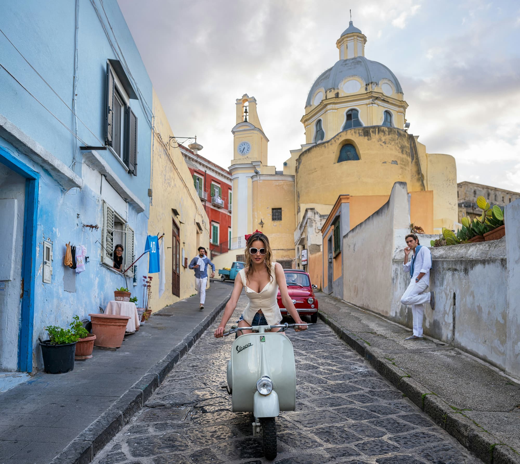"The Girl on the Vespa" by David Yarrow, Procida, Italy, 2025. Colour photograph.