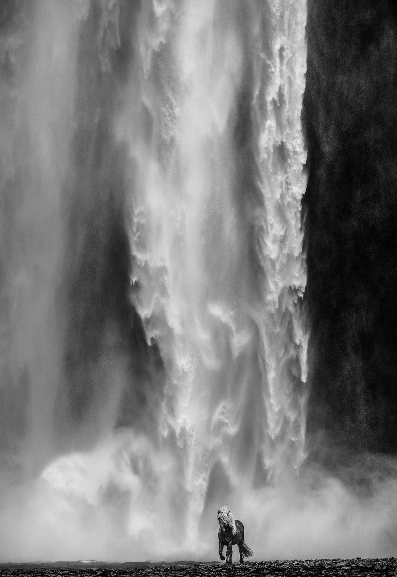 "Wonderwall" by David Yarrow, Skógafoss, Iceland, 2018. Black and white photograph.