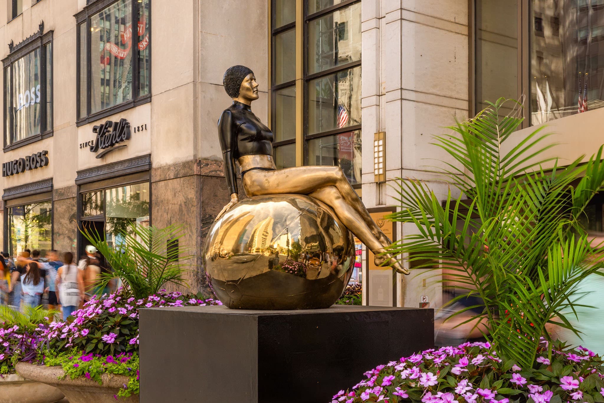 A photograph titled "Bibi on the Ball" by artist Carole Feuerman.