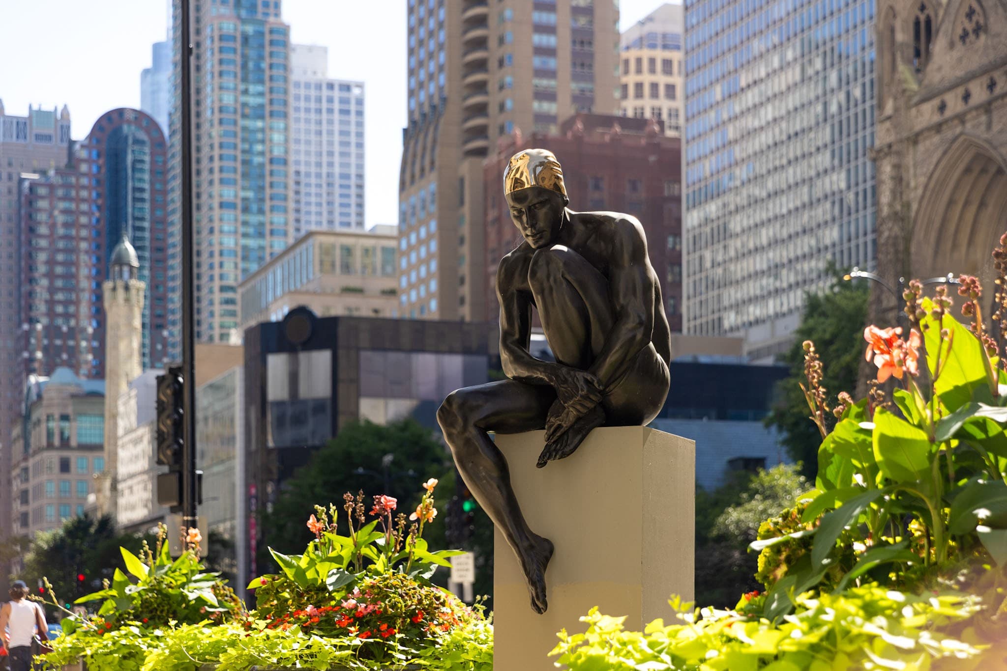 A photograph titled "The Thinker" by artist Carole Feuerman.