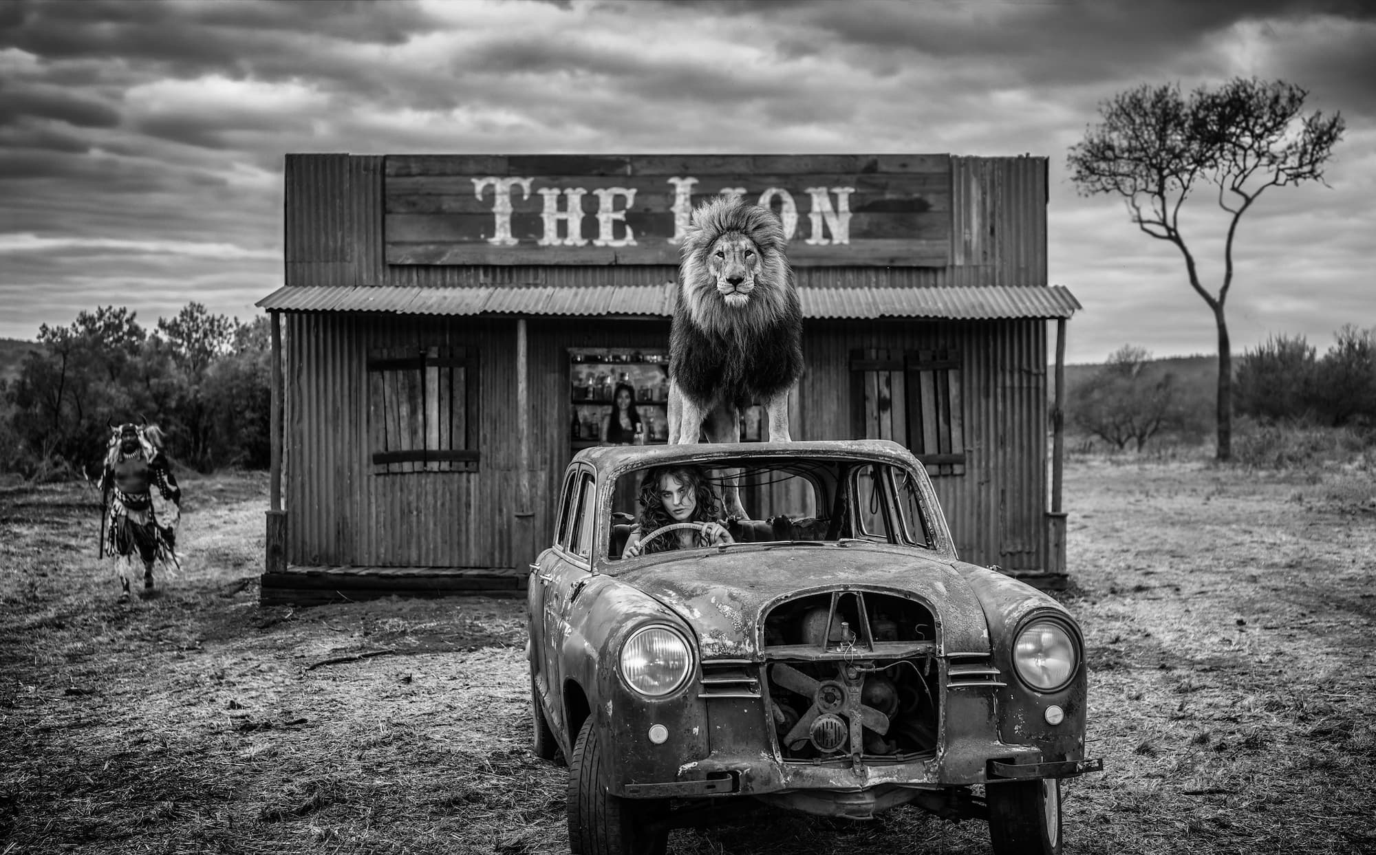 "Meet me at “The Lion”" by David Yarrow, Dinokeng, South Africa, 2026. Black and white photograph.