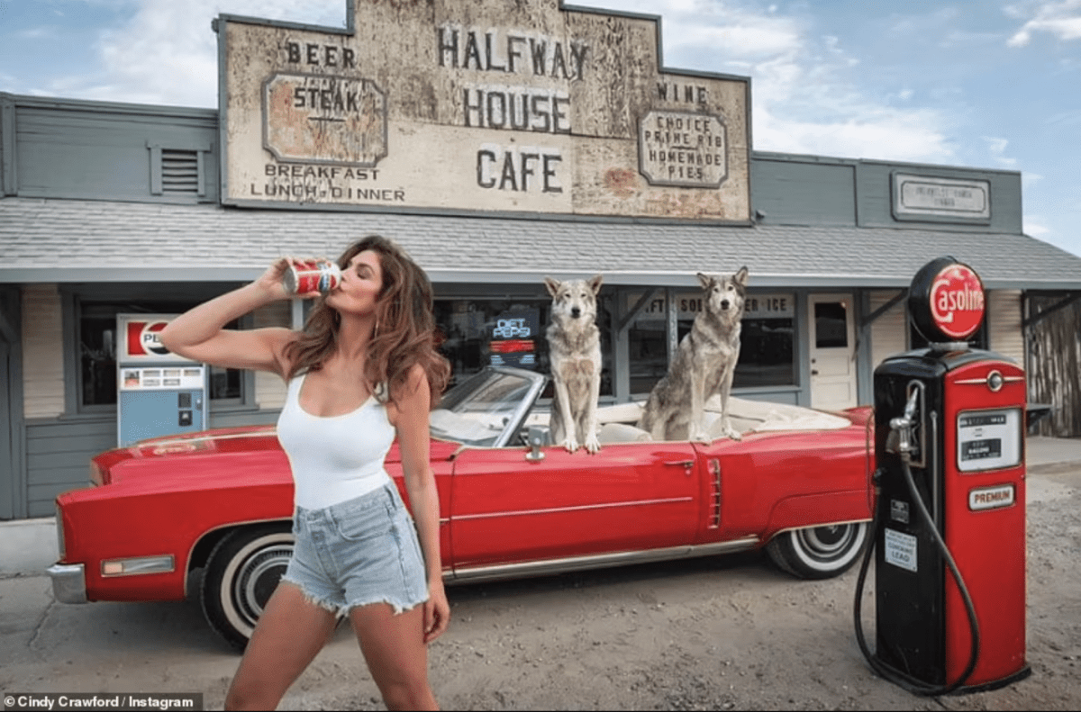 Cindy Crawford, 55, shows off her age-defying supermodel figure as she slips back into her denim hotpants to recreate her iconic 1992 Pepsi ad